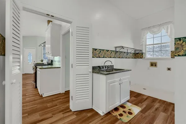 a kitchen with granite countertop white cabinets and white appliances