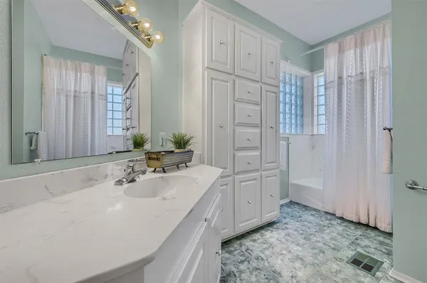 a bathroom with a double vanity sink and a mirror
