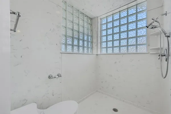 a bathroom with a bathtub and shower