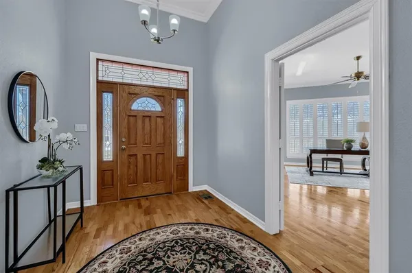 a view of a hallway view with floor to ceiling window and wooden floor