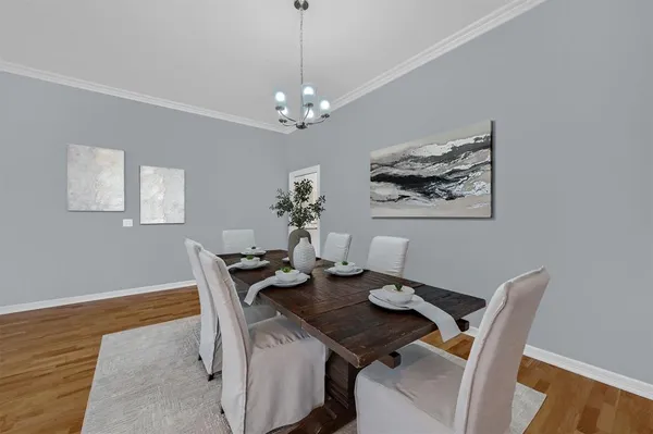 a view of a dining room with furniture wooden floor and a chandelier