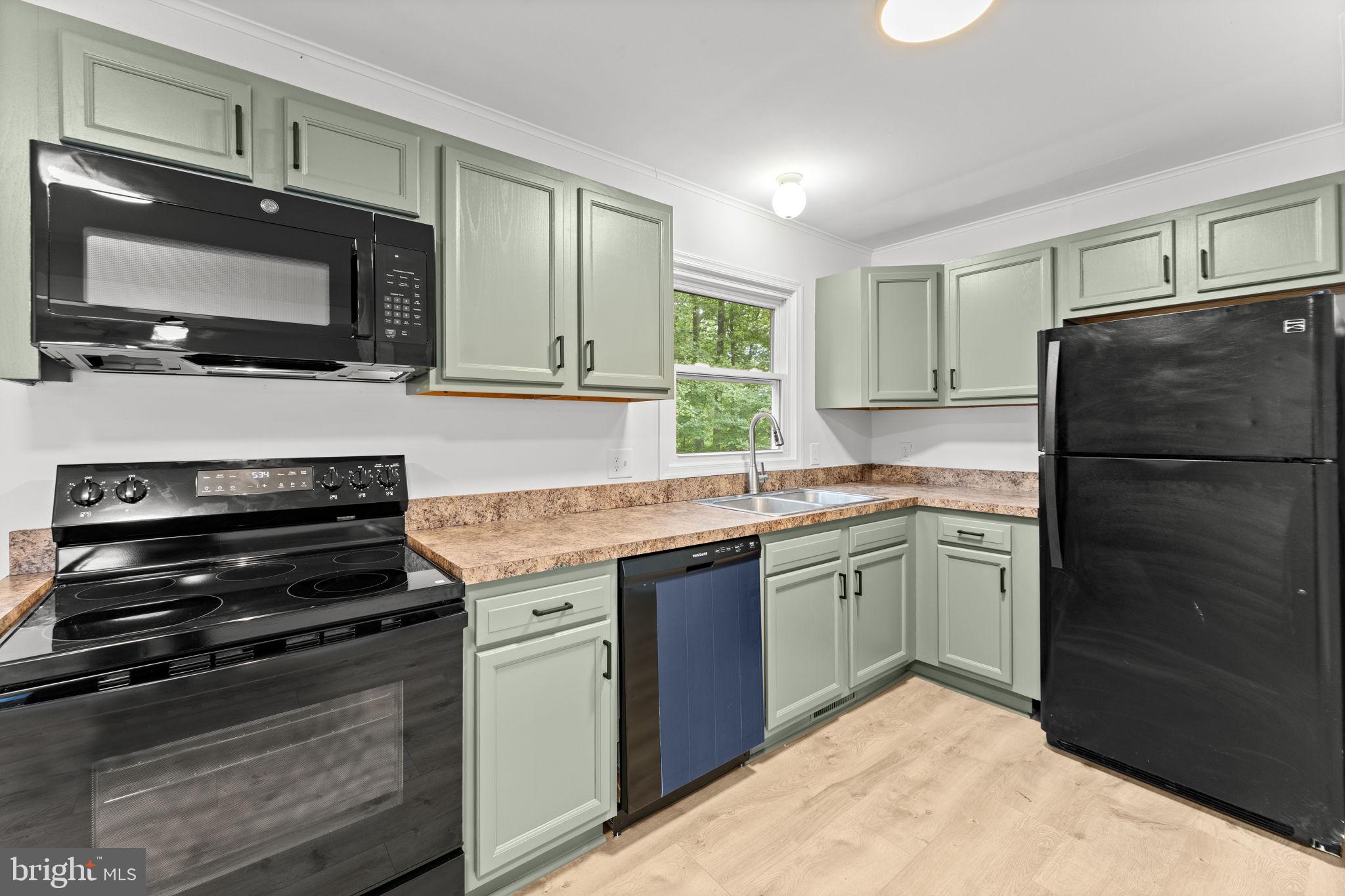 1821 James City Road Reva, VA 22735 - Photo 13 of 44 a kitchen with a refrigerator stove and microwave