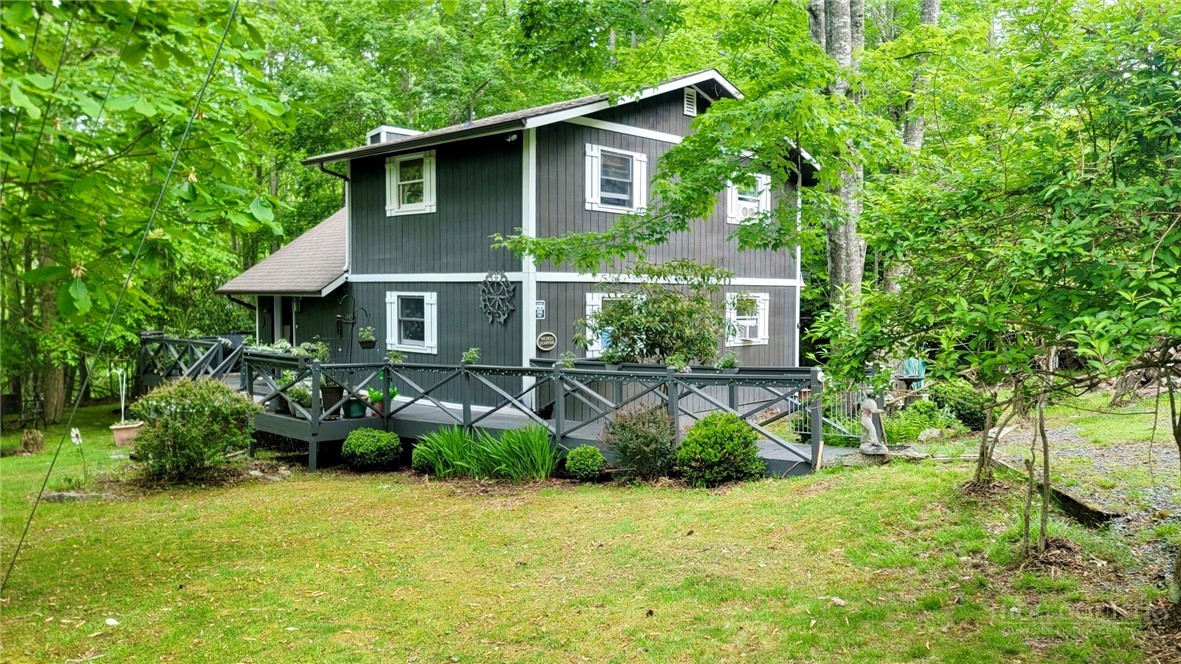 111 Locust Ridge Road Beech Mountain, NC 28604 - Photo 21 of 21 a front view of a house with garden