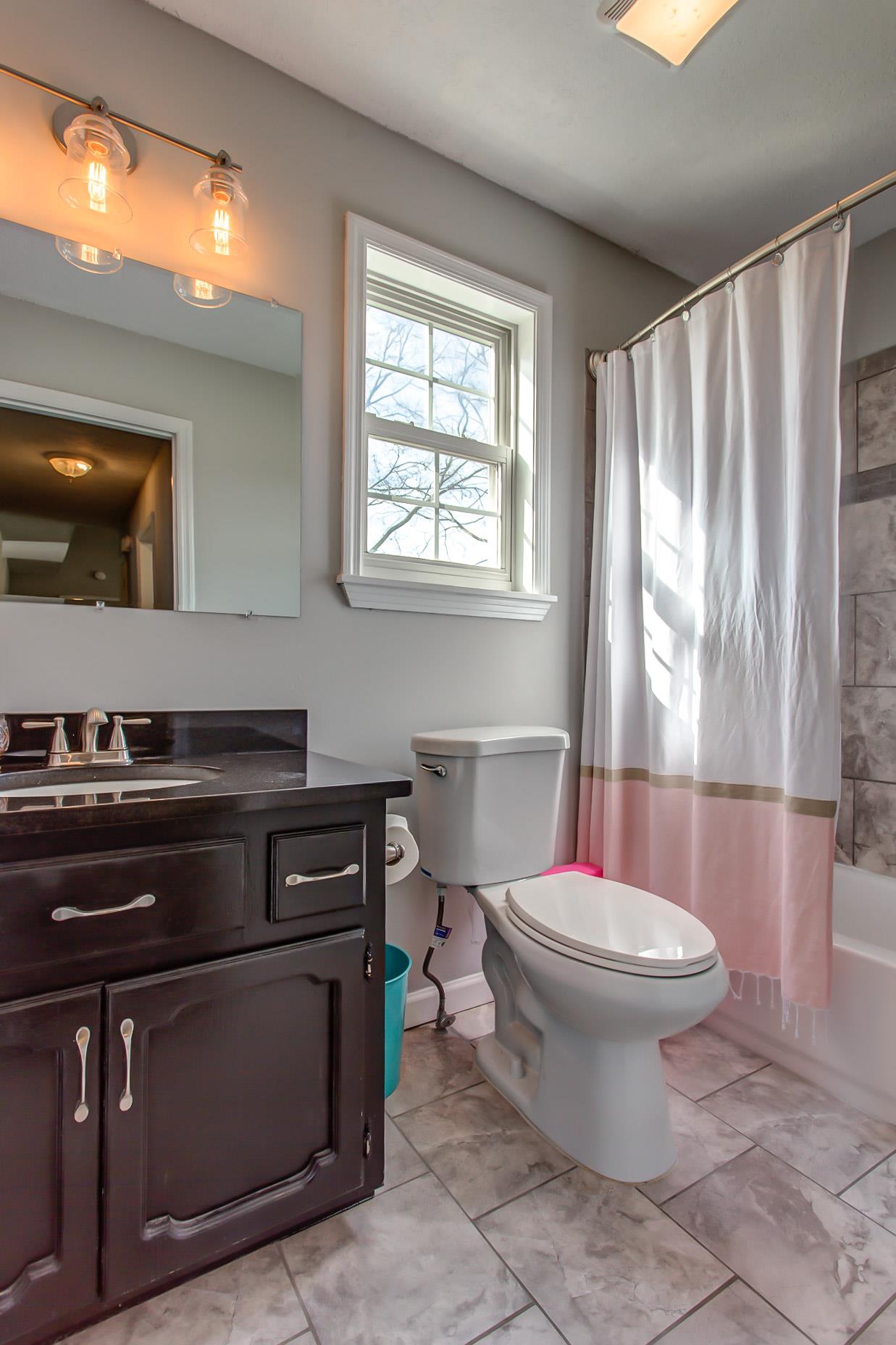 3633 Greens Mill Road Spring Hill, TN 37174 - Photo 21 of 30 a bathroom with a sink a toilet and a window