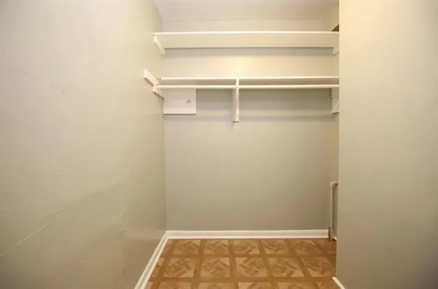 a bathroom with granite countertop white cabinets and a sink