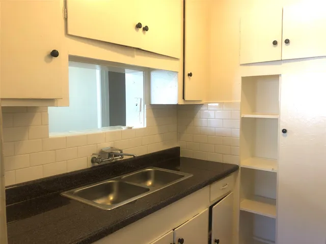 a bathroom with a sink and a window