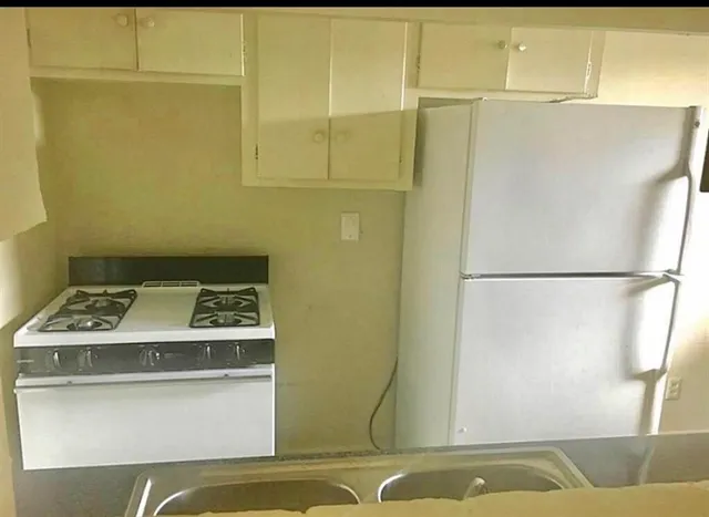a kitchen with a sink and a refrigerator