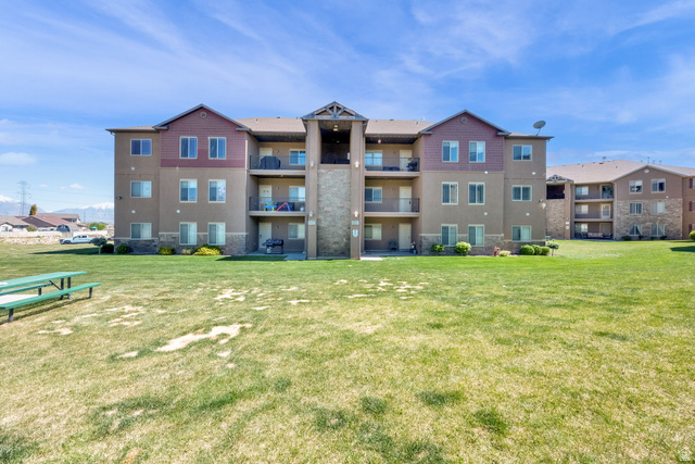 8215 Clear Rock Road, Unit 12 Eagle Mountain, UT 84005 - Photo 33 of 38 Multi-story residential building featuring stucco and stone veneer exterior finishes