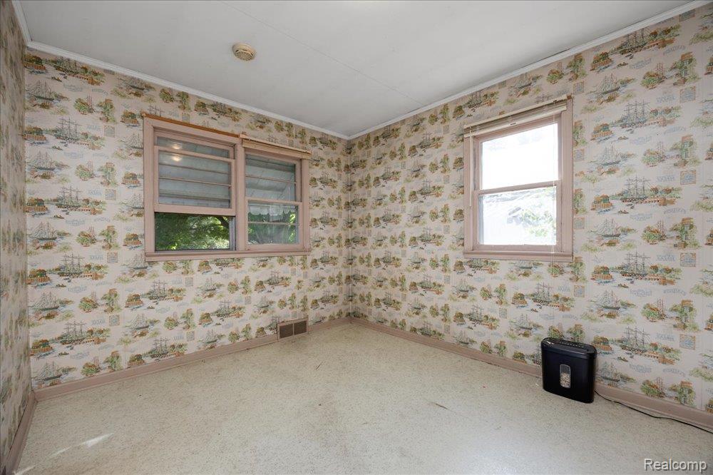 59380 10 Mile Road South Lyon, MI 48178 - Photo 24 of 53 Two windows with wood-finish trim, patterned wallpaper, and ceiling-mounted smoke detector