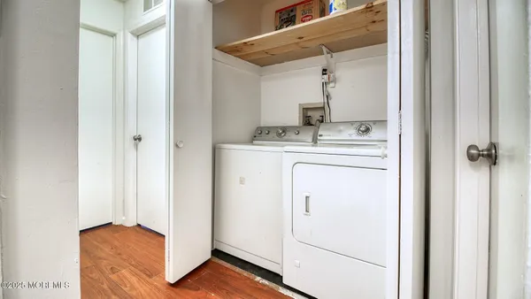 a view of a hallway with washer and dryer