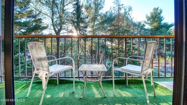 a porch with a table and chairs