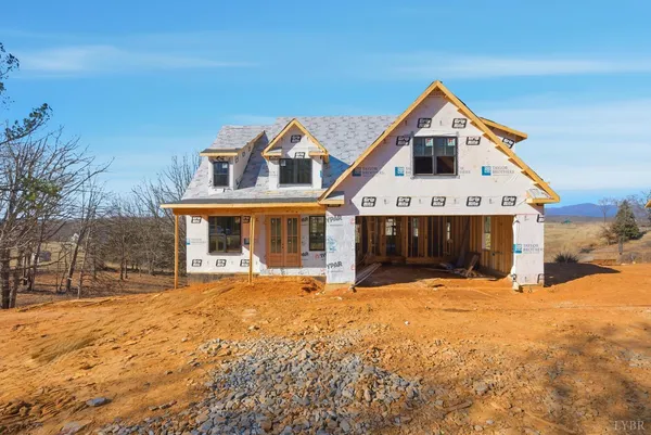 a front view of a house with a yard covered with snow in front of house
