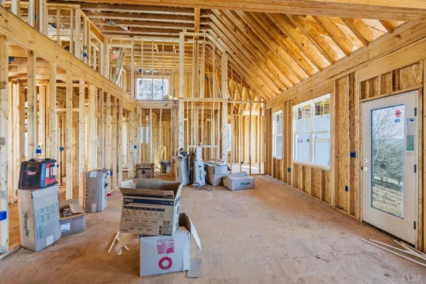 a spacious bedroom with a balcony a bed and a chandelier