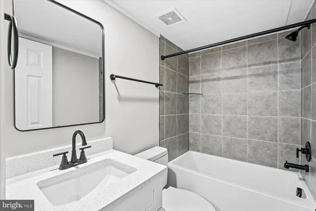 a view of a house with a big yard and large trees