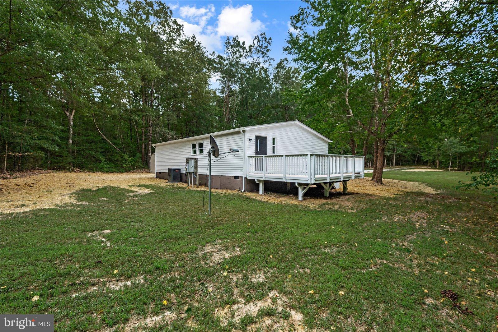 20105 Sparta Road Milford, VA 22514 - Photo 24 of 48 a view of a house with a big yard and large trees