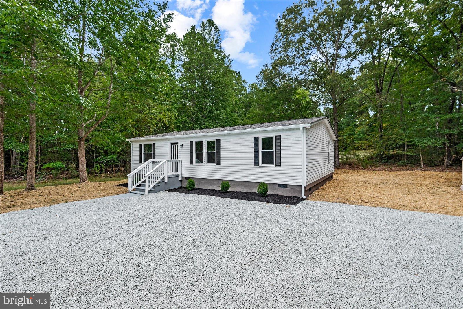 20105 Sparta Road Milford, VA 22514 - Photo 3 of 48 a view of a house with backyard and trees in the background