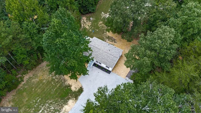 an aerial view of a house with a yard basket ball court and outdoor seating