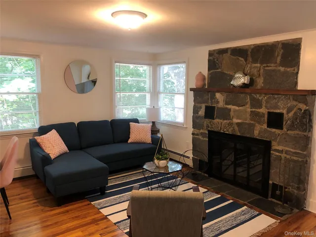 a living room with furniture a window and a fireplace