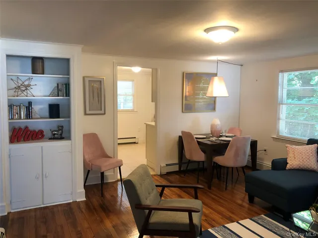 a view of a livingroom with furniture and a window