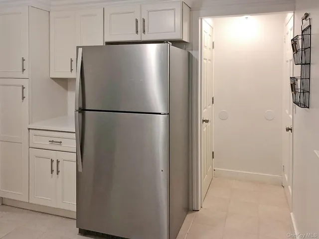 a white refrigerator freezer and a stove sitting inside of a kitchen