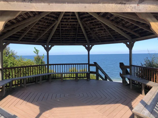 a view of balcony with wooden floor and outdoor seating