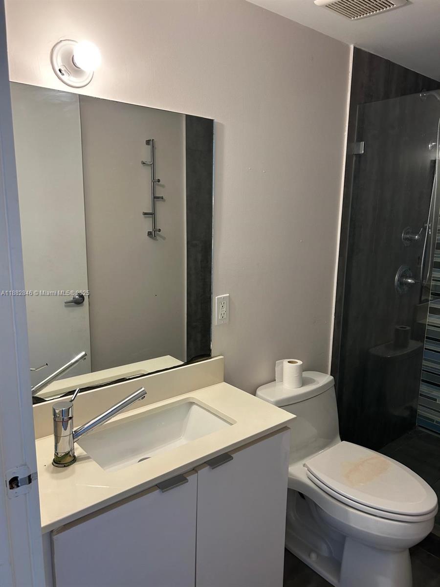 801 15th Street, Unit 206 Miami Beach, FL 33139 - Photo 4 of 10 a bathroom with a sink a toilet and shower