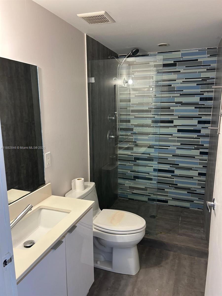 801 15th Street, Unit 206 Miami Beach, FL 33139 - Photo 5 of 10 a bathroom with a sink a toilet and shower