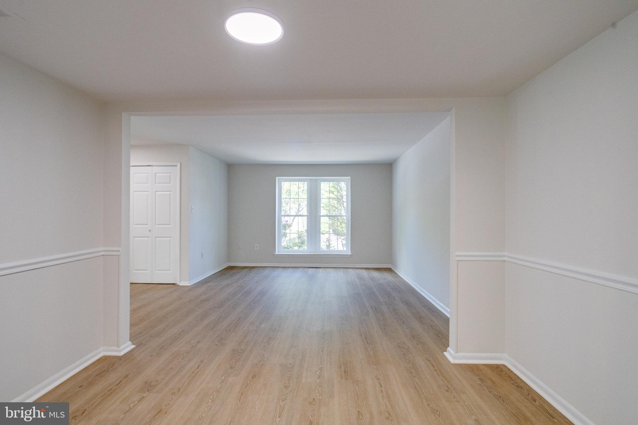 15925 Dorset Road, Unit 199 Laurel, MD 20707 - Photo 12 of 50 an empty room with wooden floor and windows