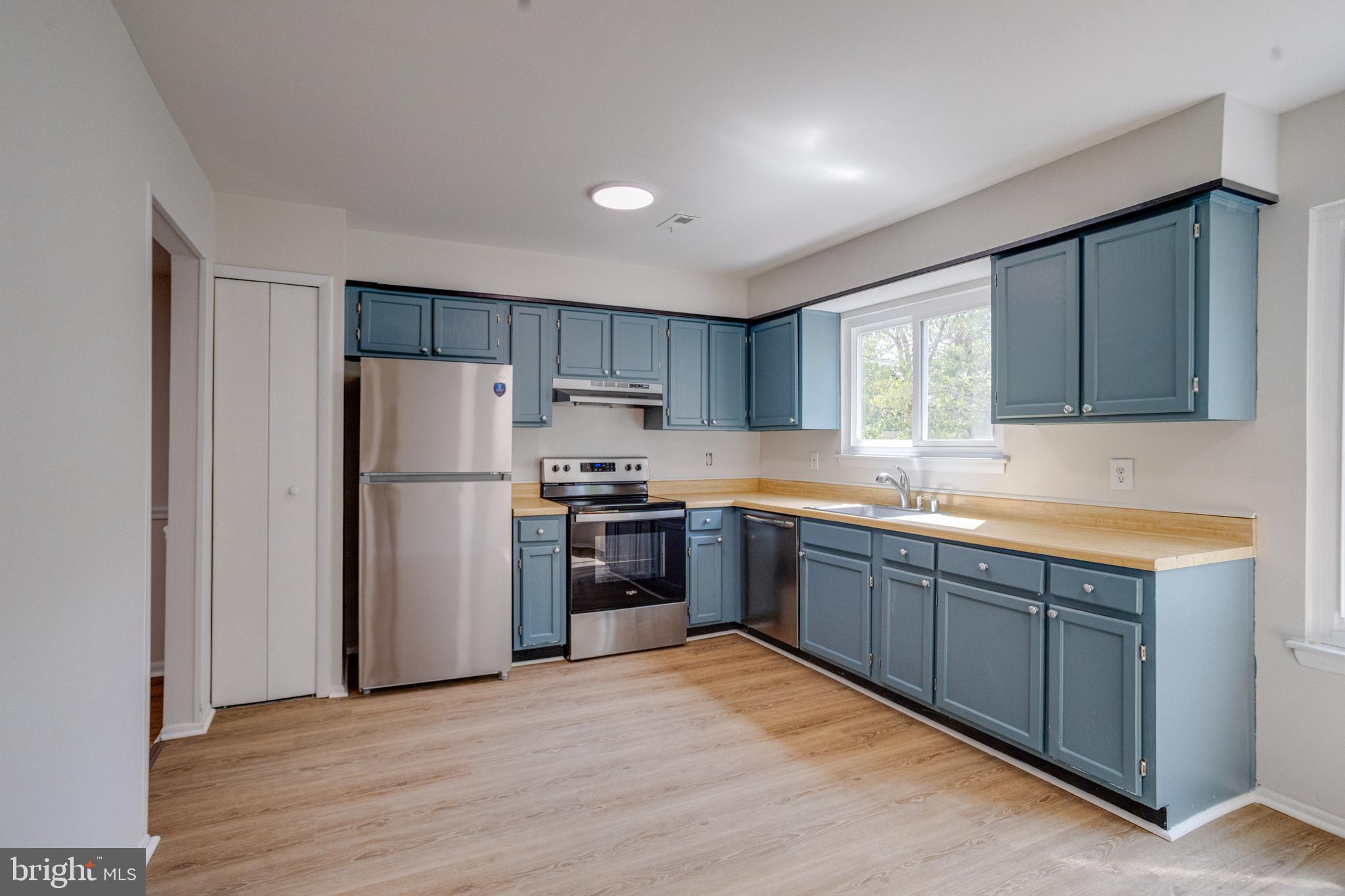 15925 Dorset Road, Unit 199 Laurel, MD 20707 - Photo 15 of 50 a kitchen with stainless steel appliances granite countertop a refrigerator sink and wooden cabinets