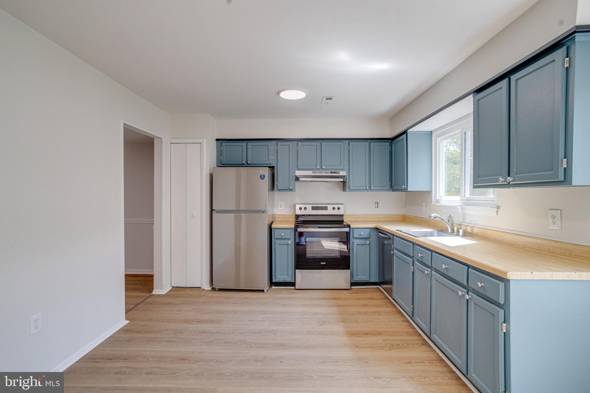 15925 Dorset Road, Unit 199 Laurel, MD 20707 - Photo 16 of 50 a kitchen with stainless steel appliances granite countertop a refrigerator and a stove top oven