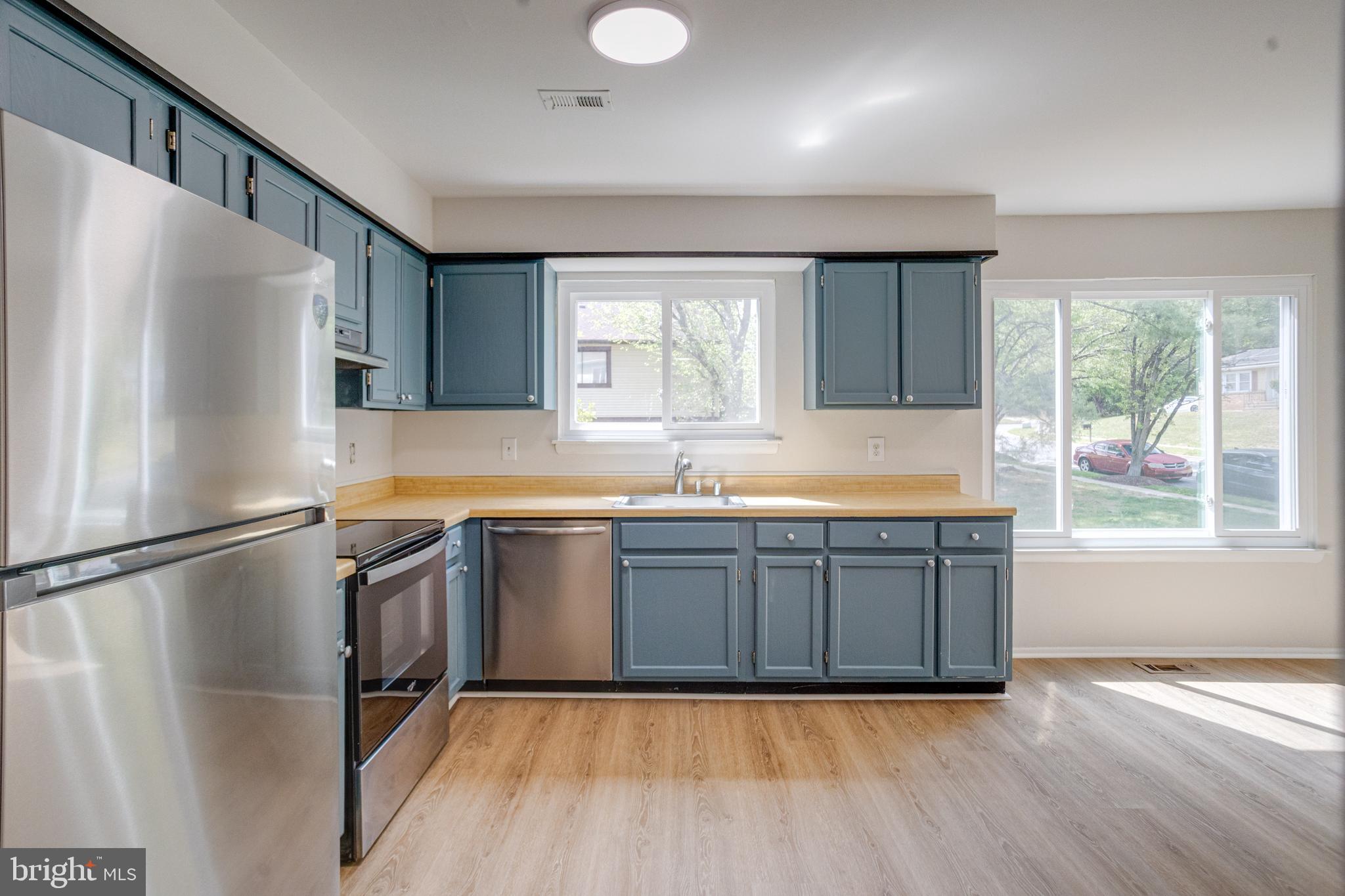 15925 Dorset Road, Unit 199 Laurel, MD 20707 - Photo 17 of 50 a kitchen with granite countertop stainless steel appliances a refrigerator sink and wooden cabinets