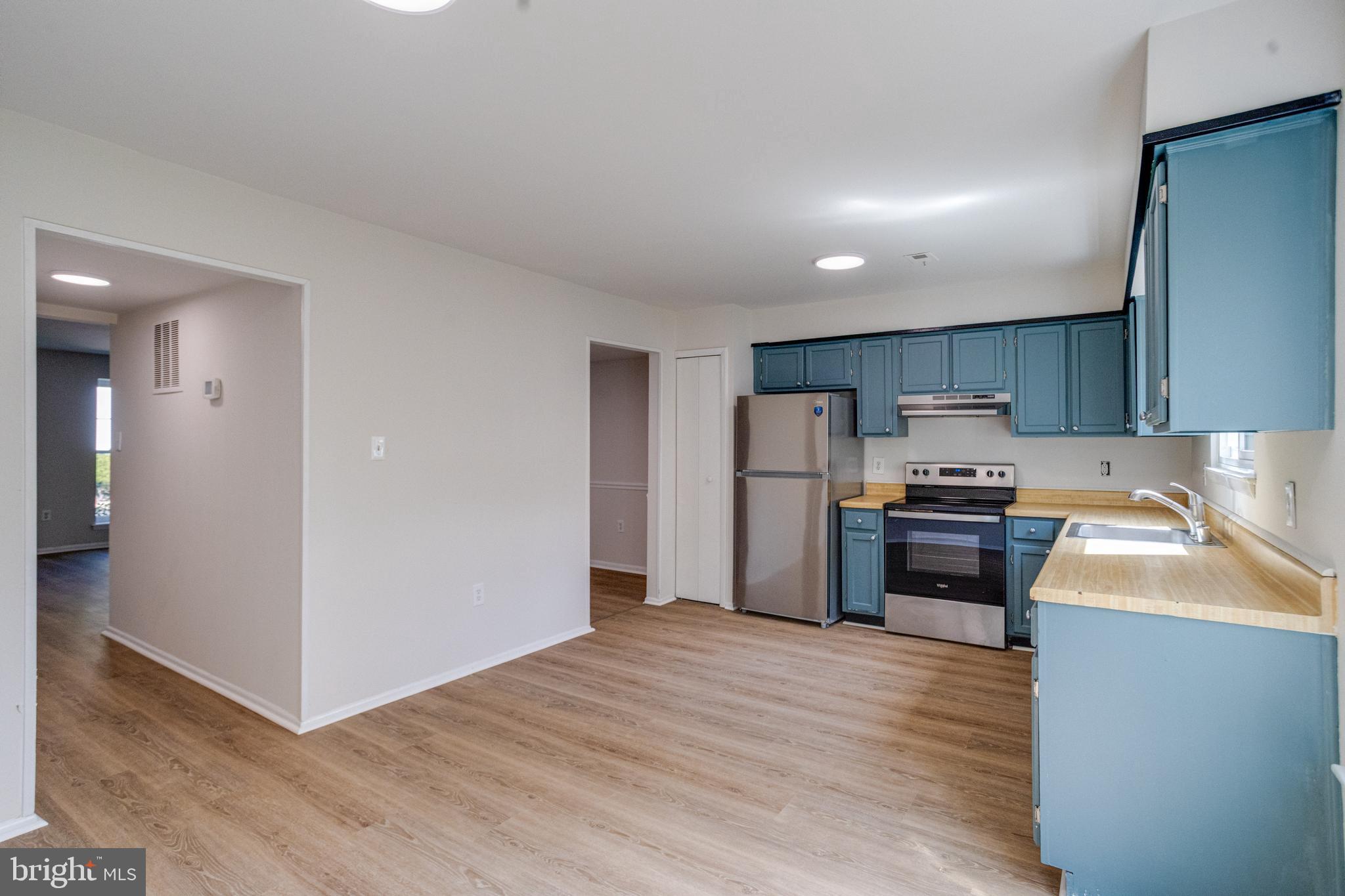 15925 Dorset Road, Unit 199 Laurel, MD 20707 - Photo 19 of 50 a kitchen with stainless steel appliances granite countertop a refrigerator stove top oven and sink