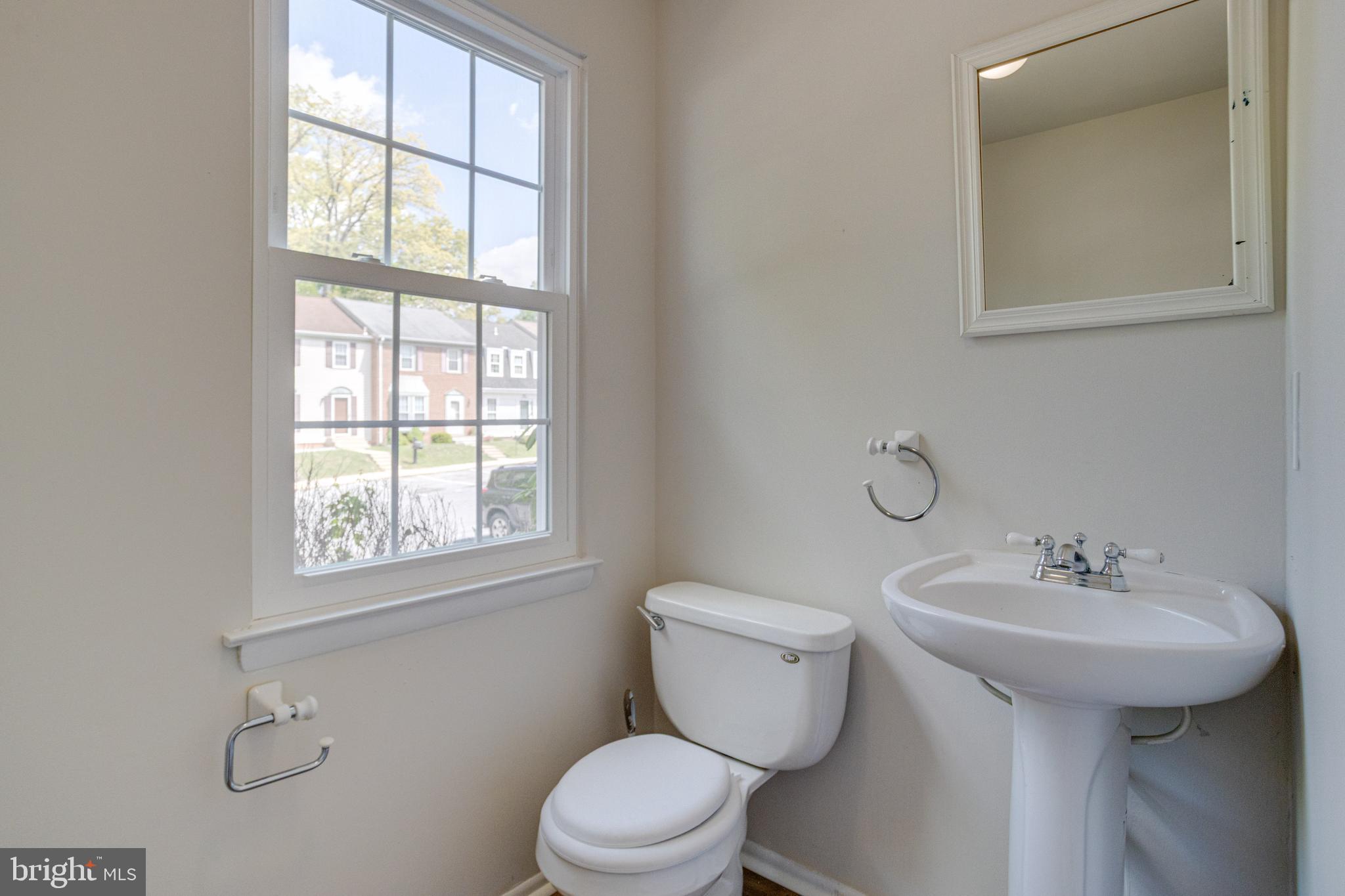 15925 Dorset Road, Unit 199 Laurel, MD 20707 - Photo 20 of 50 a bathroom with a sink toilet and a window