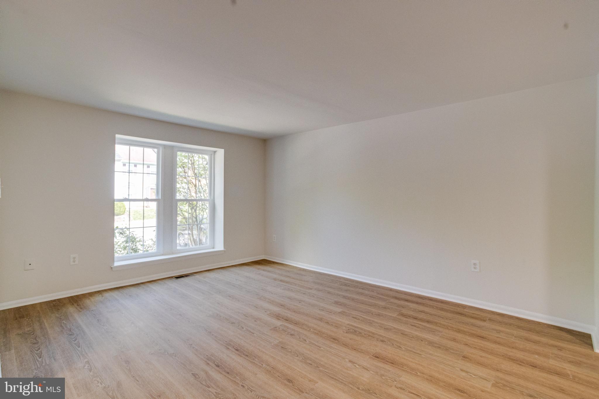 15925 Dorset Road, Unit 199 Laurel, MD 20707 - Photo 4 of 50 an empty room with wooden floor and windows