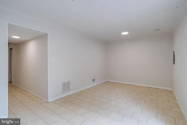 an empty room with a fireplace and cabinet