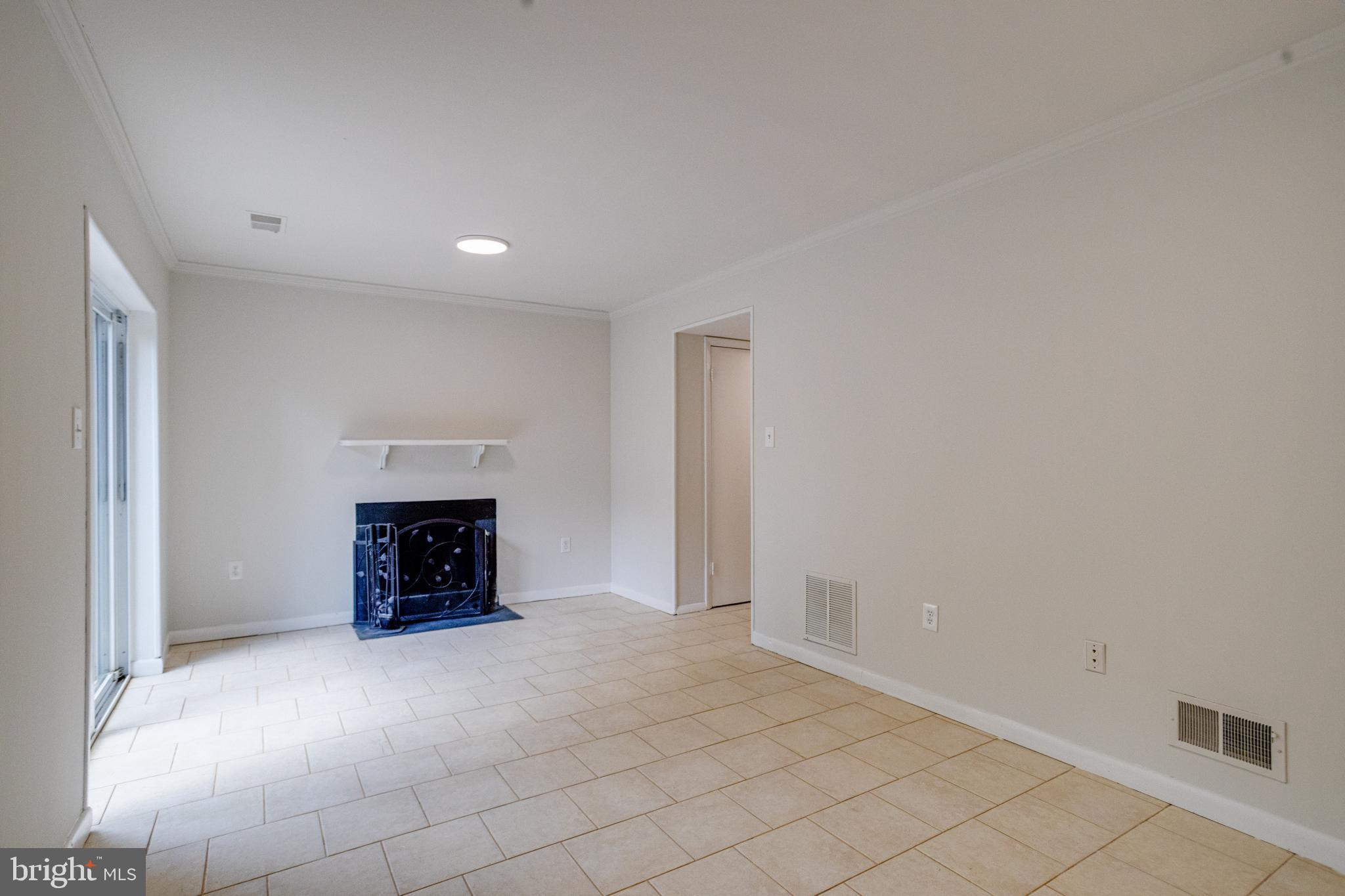 15925 Dorset Road, Unit 199 Laurel, MD 20707 - Photo 42 of 50 an empty room with a fireplace and cabinet