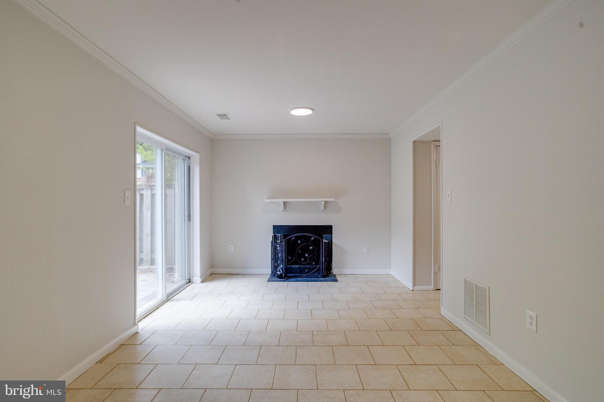 15925 Dorset Road, Unit 199 Laurel, MD 20707 - Photo 43 of 50 an empty room with fireplace and window