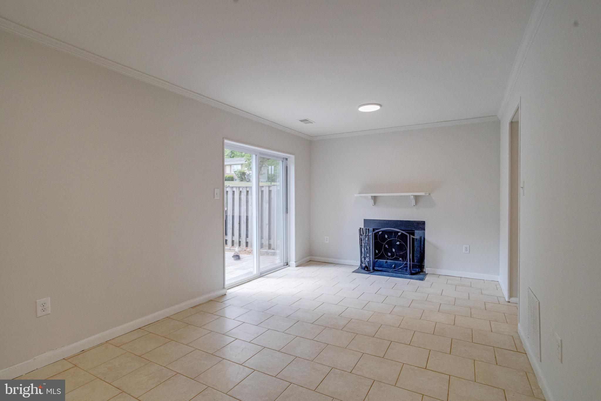 15925 Dorset Road, Unit 199 Laurel, MD 20707 - Photo 44 of 50 an empty room with fireplace and windows