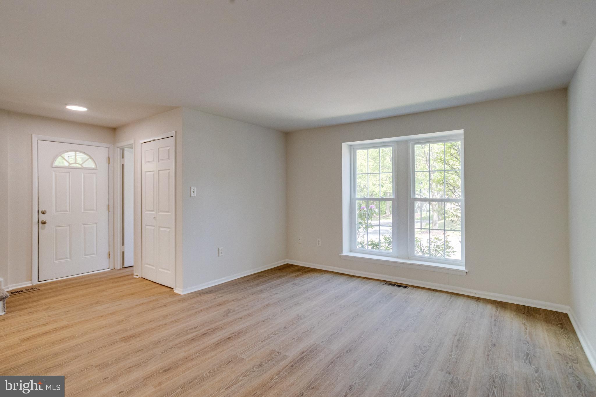 15925 Dorset Road, Unit 199 Laurel, MD 20707 - Photo 6 of 50 a view of an empty room with wooden floor and window