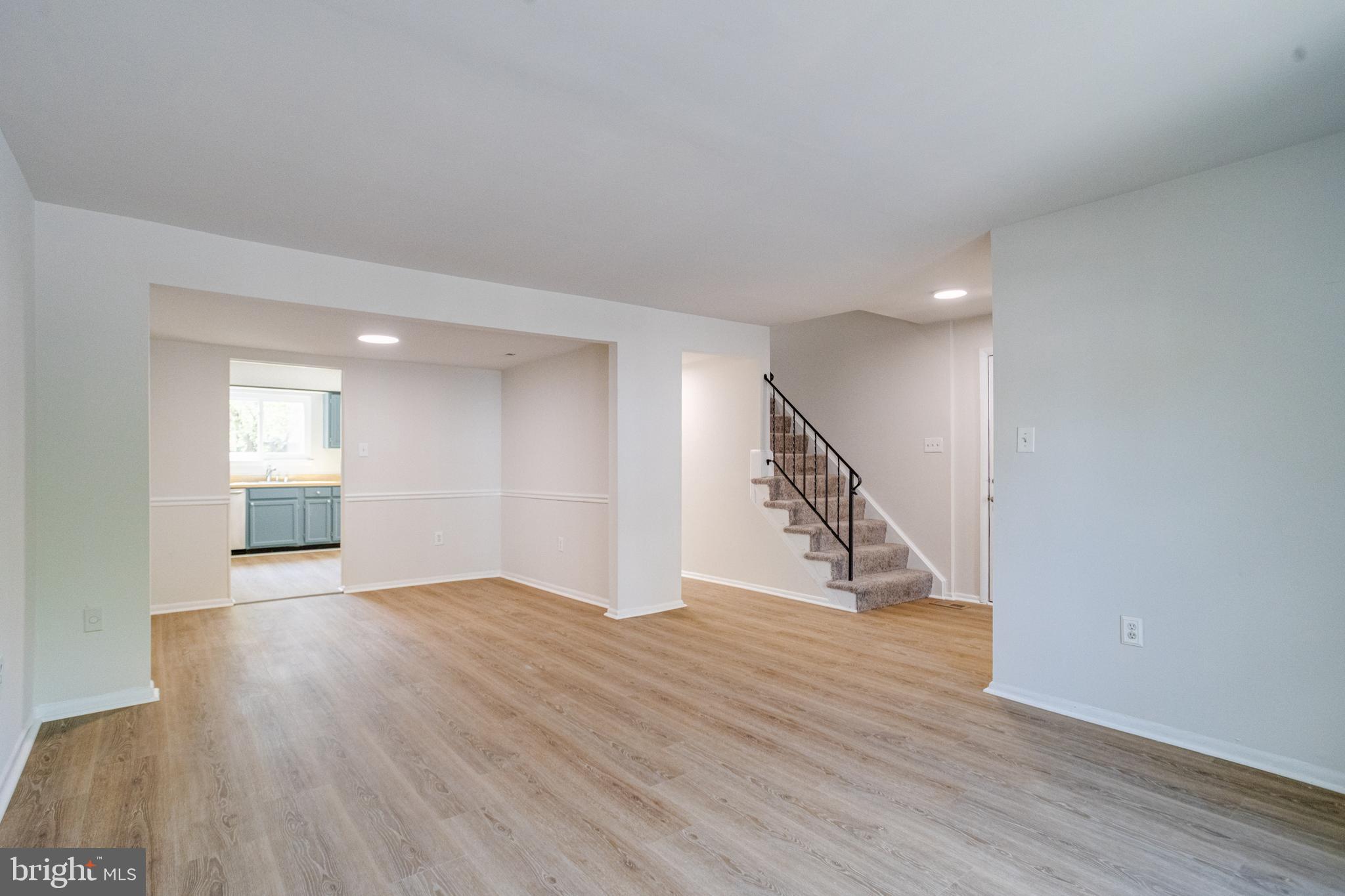 15925 Dorset Road, Unit 199 Laurel, MD 20707 - Photo 7 of 50 a view of an empty room with wooden floor and stairs