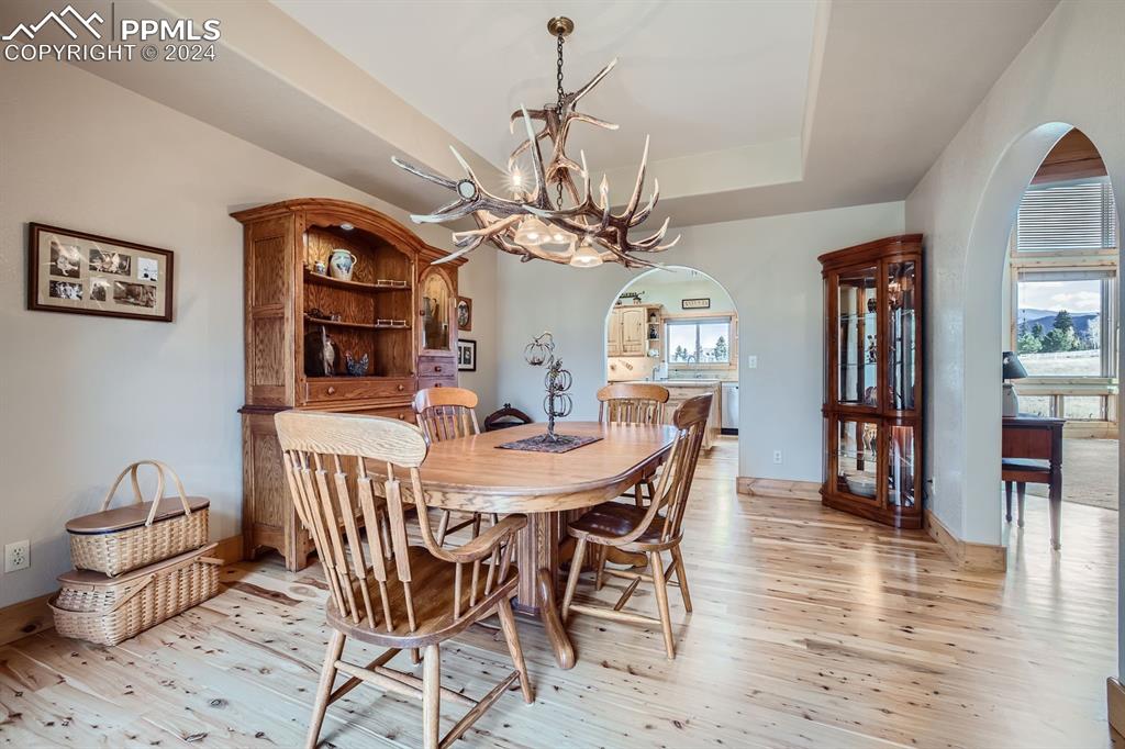 182 Joshua Road Divide, CO 80814 - Photo 14 of 41 a view of a dining room with furniture and chandelier