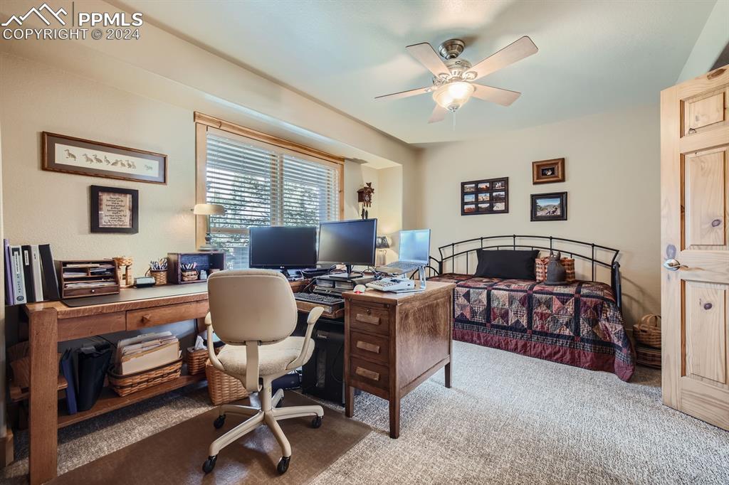 182 Joshua Road Divide, CO 80814 - Photo 16 of 41 a living room with furniture and a chandelier