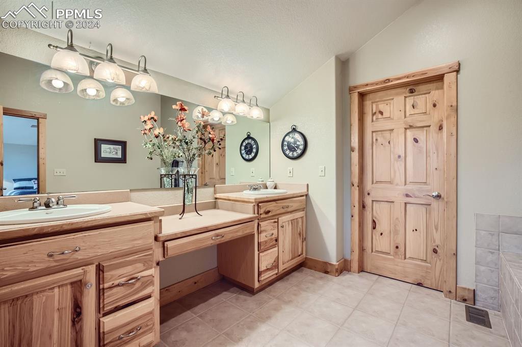 182 Joshua Road Divide, CO 80814 - Photo 24 of 41 a spacious bathroom with a double vanity sink and a mirror