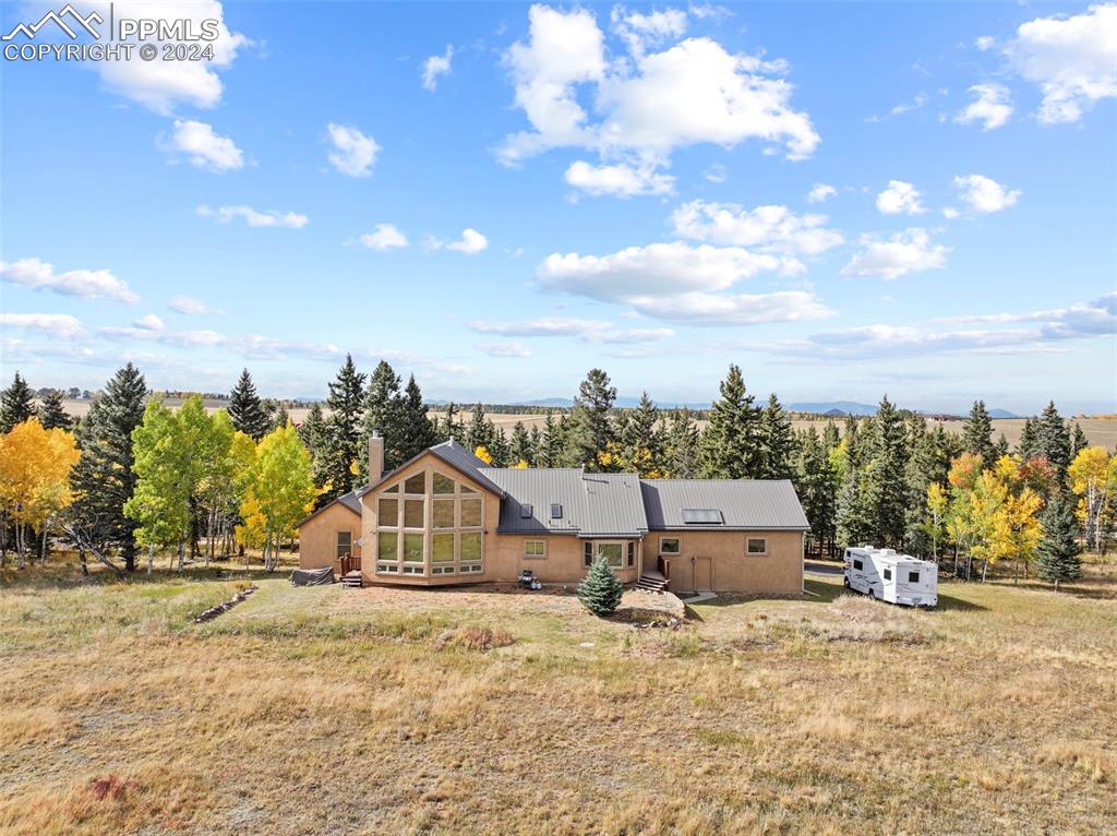 182 Joshua Road Divide, CO 80814 - Photo 33 of 41 a big house with a big yard and large trees
