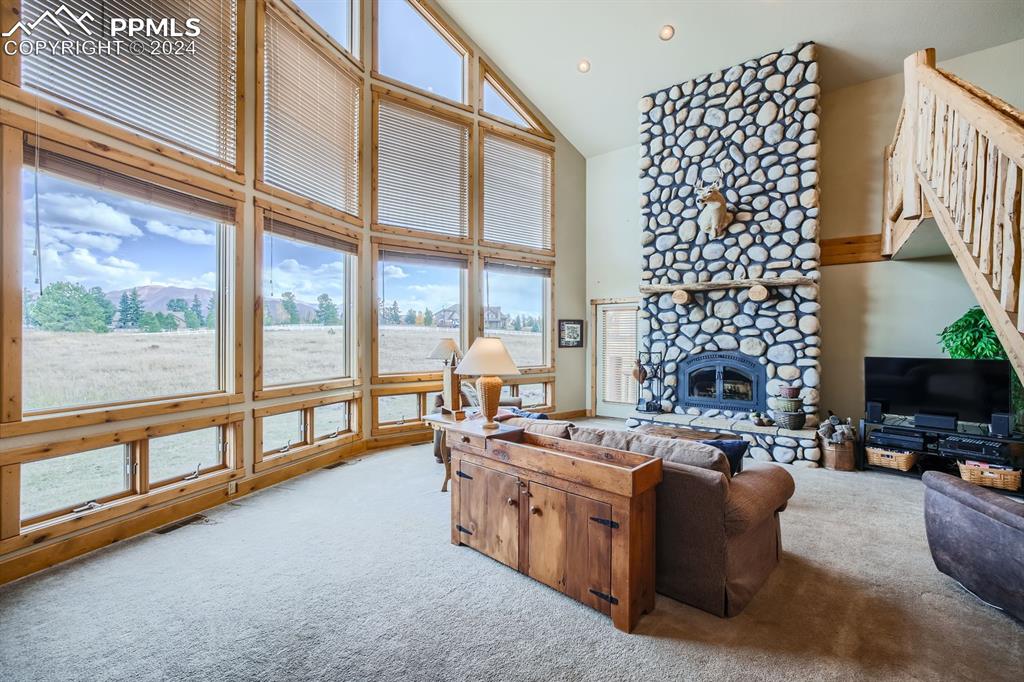 182 Joshua Road Divide, CO 80814 - Photo 6 of 41 a living room with furniture fireplace and a large window