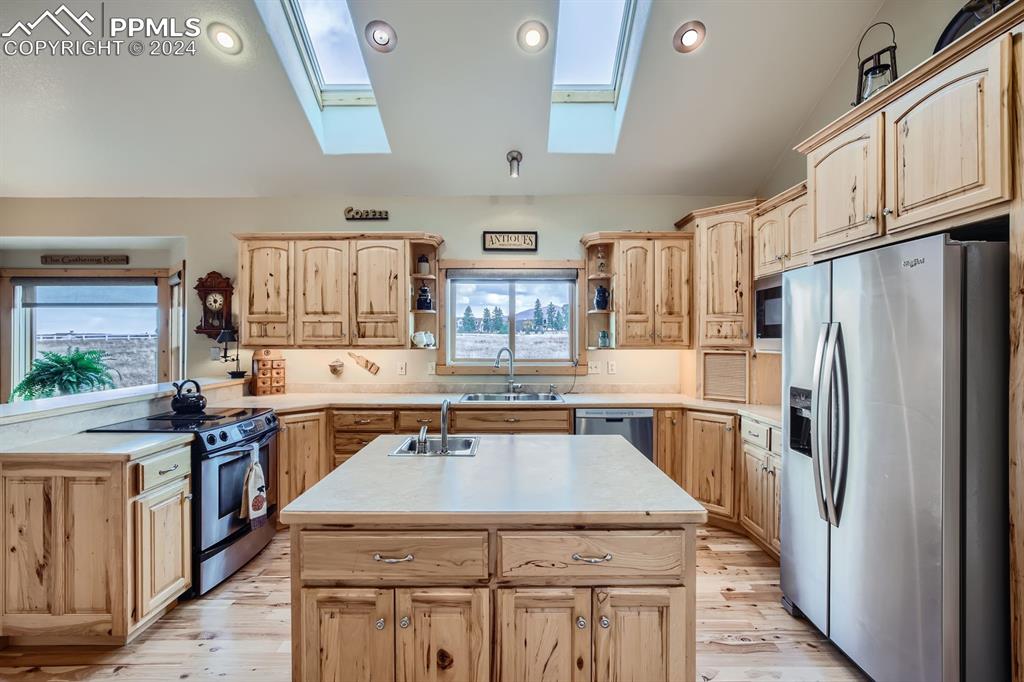 182 Joshua Road Divide, CO 80814 - Photo 8 of 41 a kitchen with stainless steel appliances granite countertop a stove refrigerator sink and cabinets
