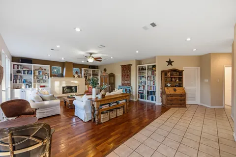a living room with furniture and cabinets