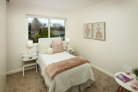 a bedroom with a bed and a window