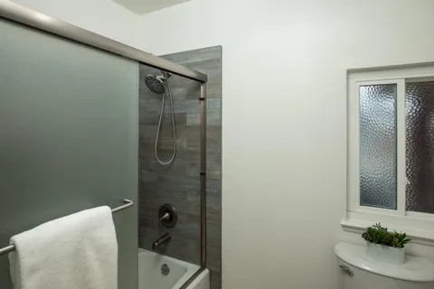 a bathroom with a bathtub and shower