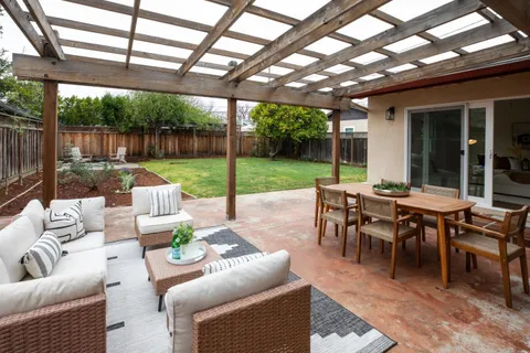 a view of a patio with a dining table and chairs